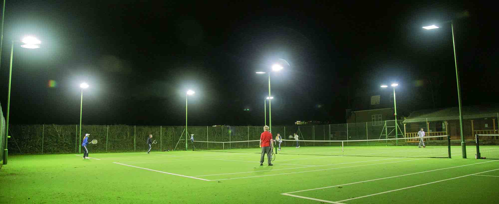 Floodlit tennis courts on a Thursday evening in Stoke Poges